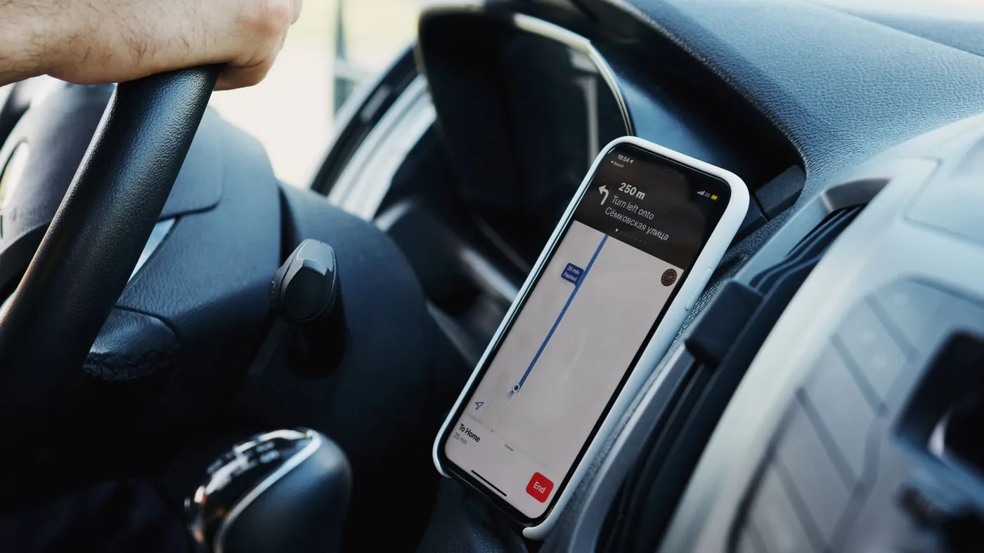 Phone on a car dashboard showing GPS navigation